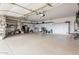 Spacious garage with ample storage and epoxy flooring, perfect for organization and projects at 18247 N 168Th Cir, Surprise, AZ 85374