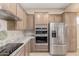 Modern kitchen boasting stainless steel appliances, light wood cabinetry, and stone countertops at 18247 N 168Th Cir, Surprise, AZ 85374