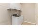 The laundry room features a modern washer and dryer set with sleek white cabinetry above at 18247 N 168Th Cir, Surprise, AZ 85374
