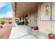 Relaxing covered patio area with comfortable seating, ideal for outdoor lounging and entertaining at 18247 N 168Th Cir, Surprise, AZ 85374