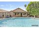 Inviting backyard featuring a refreshing pool, covered patio, and lush landscaping at 1962 E Morrow Dr, Phoenix, AZ 85024