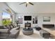 Cozy living room features a vaulted ceiling, large windows, fireplace, and modern furnishings at 1962 E Morrow Dr, Phoenix, AZ 85024
