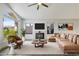 Bright living room with fireplace, leather seating, and large windows at 1962 E Morrow Dr, Phoenix, AZ 85024