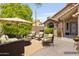 Inviting outdoor patio featuring comfortable seating, an umbrella, and a charming, well-manicured garden at 1962 E Morrow Dr, Phoenix, AZ 85024