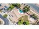 Aerial view of a private backyard oasis featuring a swimming pool with a rock waterfall and a basketball court at 19903 S 187Th Dr, Queen Creek, AZ 85142