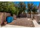 Spacious backyard including gravel, block wall and blue water barrels at 19903 S 187Th Dr, Queen Creek, AZ 85142