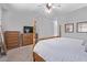 Bedroom showcasing a four-poster bed, wood dressers, and wall art at 19903 S 187Th Dr, Queen Creek, AZ 85142