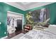 Bedroom featuring bright green walls, closet and bed with grey patterned blanket at 19903 S 187Th Dr, Queen Creek, AZ 85142