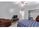 Comfortable bedroom featuring a bed, a TV, and generous seating at 19903 S 187Th Dr, Queen Creek, AZ 85142
