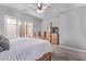 Spacious bedroom featuring a four-poster bed, shuttered windows, and soft carpet at 19903 S 187Th Dr, Queen Creek, AZ 85142