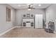 Bonus room featuring light grey walls, wood-look floors, ceiling fan and kitchenette at 19903 S 187Th Dr, Queen Creek, AZ 85142