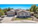 Charming single-story home showcasing a manicured front lawn, mature trees, and an attached garage at 19903 S 187Th Dr, Queen Creek, AZ 85142