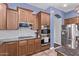 Kitchen with stainless appliances, stone countertops, and light-filled window at 19903 S 187Th Dr, Queen Creek, AZ 85142