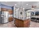 Kitchen island with granite countertops and wooden cabinets at 19903 S 187Th Dr, Queen Creek, AZ 85142