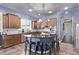 Spacious kitchen with custom cabinets, stainless appliances, an island, and tile flooring at 19903 S 187Th Dr, Queen Creek, AZ 85142