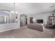 Comfortable living room with a cozy couch, neutral walls, and abundant natural light from large windows at 19903 S 187Th Dr, Queen Creek, AZ 85142