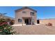 The backyard of a two-story home featuring a covered patio and low-maintenance landscaping at 23929 W Twilight Trl, Buckeye, AZ 85326