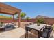 Backyard features an ample patio, outdoor seating, and a low-maintenance xeriscaped yard at 23929 W Twilight Trl, Buckeye, AZ 85326