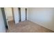 Clean bedroom featuring neutral carpet, a closet with sliding doors, and a view of the hallway at 23929 W Twilight Trl, Buckeye, AZ 85326