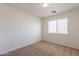 Bedroom featuring neutral carpet, a window with blinds, and ample natural light at 23929 W Twilight Trl, Buckeye, AZ 85326
