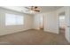 Bedroom with neutral walls, carpet, bright window, and ceiling fan at 23929 W Twilight Trl, Buckeye, AZ 85326