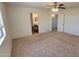 Spacious bedroom featuring neutral carpet, a ceiling fan and ensuite bathroom access at 23929 W Twilight Trl, Buckeye, AZ 85326