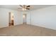 Bedroom featuring neutral walls, carpet, and doors to bathroom at 23929 W Twilight Trl, Buckeye, AZ 85326