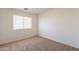 Bright bedroom with neutral carpet and a window with white blinds at 23929 W Twilight Trl, Buckeye, AZ 85326