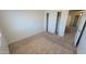 A clean bedroom features neutral carpet and a closet with sliding doors at 23929 W Twilight Trl, Buckeye, AZ 85326