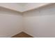 Open walk-in closet providing ample storage space and neutral carpet at 23929 W Twilight Trl, Buckeye, AZ 85326