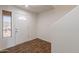 Bright entryway with wood flooring, white walls, and natural light from the window at 23929 W Twilight Trl, Buckeye, AZ 85326
