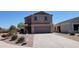 Charming two-story home with a well-maintained yard and a concrete driveway on a clear day at 23929 W Twilight Trl, Buckeye, AZ 85326
