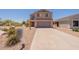 Two-story home featuring a neutral stucco exterior, gray garage door, and low-maintenance landscaping at 23929 W Twilight Trl, Buckeye, AZ 85326