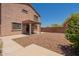 Exterior view of a two-story home featuring a backyard and a covered patio at 23929 W Twilight Trl, Buckeye, AZ 85326