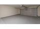 A spacious garage with epoxy floors and an insulated door for easy parking at 23929 W Twilight Trl, Buckeye, AZ 85326