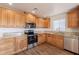 Modern kitchen with stainless steel appliances, granite countertops, and wood-look flooring at 23929 W Twilight Trl, Buckeye, AZ 85326