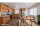 Stylish kitchen with wood cabinets, stainless steel appliances, and a dining table for modern living at 23929 W Twilight Trl, Buckeye, AZ 85326