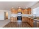 Updated kitchen featuring stainless steel appliances, wood cabinetry, and granite countertops at 23929 W Twilight Trl, Buckeye, AZ 85326