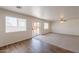 Bright and spacious living room featuring neutral carpet and a sliding glass door to the outside at 23929 W Twilight Trl, Buckeye, AZ 85326