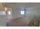 Open-concept living room with a ceiling fan and view from the staircase landing at 23929 W Twilight Trl, Buckeye, AZ 85326