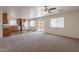 Open-concept living space flows into a modern kitchen with stainless steel appliances and wood-look floors at 23929 W Twilight Trl, Buckeye, AZ 85326