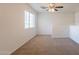 Loft area with neutral walls, carpet, and bright window at 23929 W Twilight Trl, Buckeye, AZ 85326