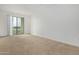 Spacious bedroom featuring plush carpeting and sliding glass doors leading to a balcony at 2511 W Queen Creek Rd # 378, Chandler, AZ 85248