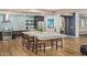 A clubhouse kitchen area featuring an island with seating, stainless appliances, and modern finishes at 2511 W Queen Creek Rd # 378, Chandler, AZ 85248