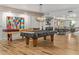 A stylish game room offering a shuffleboard table, pool table, and additional seating areas at 2511 W Queen Creek Rd # 378, Chandler, AZ 85248