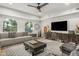 A spacious living room boasts a ceiling fan, stylish furniture, and a large window with plenty of sunlight at 2511 W Queen Creek Rd # 378, Chandler, AZ 85248