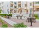 Convenient outdoor kitchen and dining area with stainless steel grills and comfortable seating, surrounded by lush greenery at 2511 W Queen Creek Rd # 378, Chandler, AZ 85248