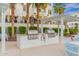Outdoor kitchen with built-in grills and seating, surrounded by lush landscaping for a perfect outdoor dining experience at 2511 W Queen Creek Rd # 378, Chandler, AZ 85248