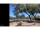 Tennis courts with desert landscaping and a glimpse of nearby residential buildings at 2511 W Queen Creek Rd # 378, Chandler, AZ 85248