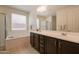 Bathroom featuring double sinks, a bathtub, and a shower at 2543 W Rabjohn Rd, Phoenix, AZ 85085